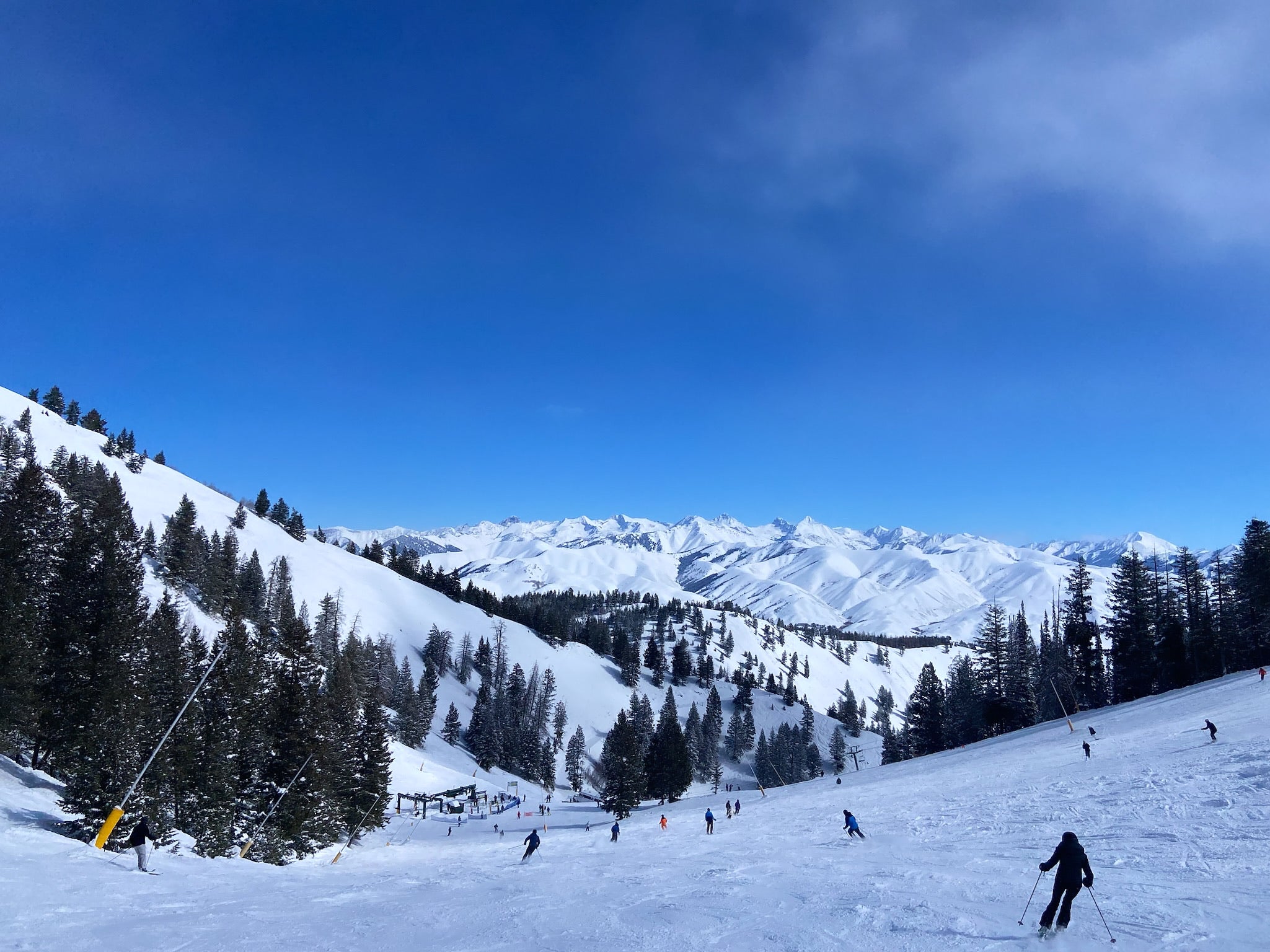 Skiers skiing down snowy mountain