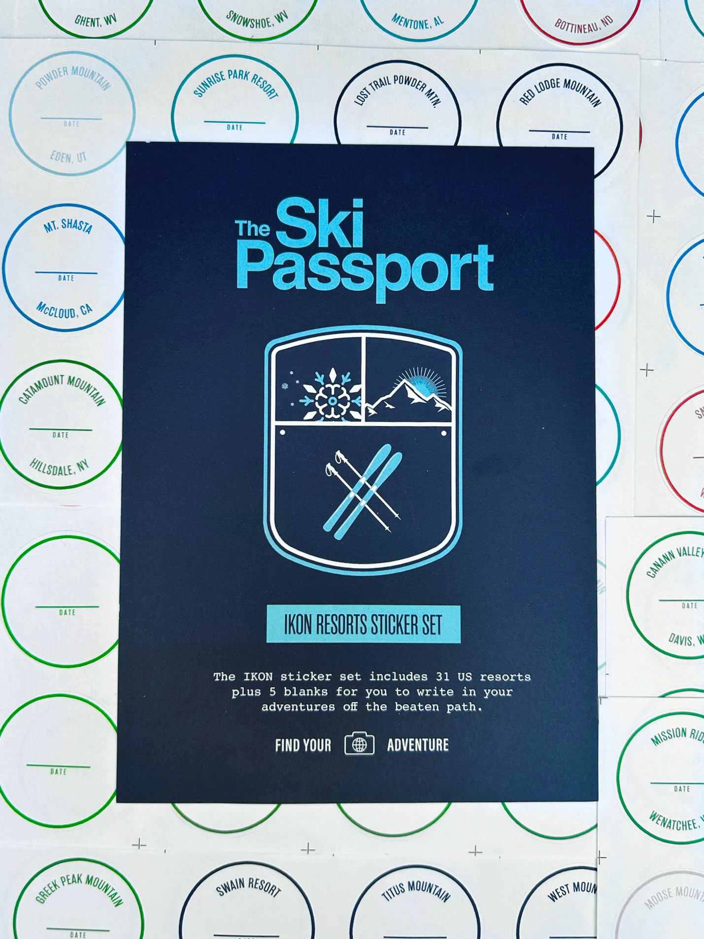 The Ski Passport Ikon ski resort sticker set with ski resort stickers in the background