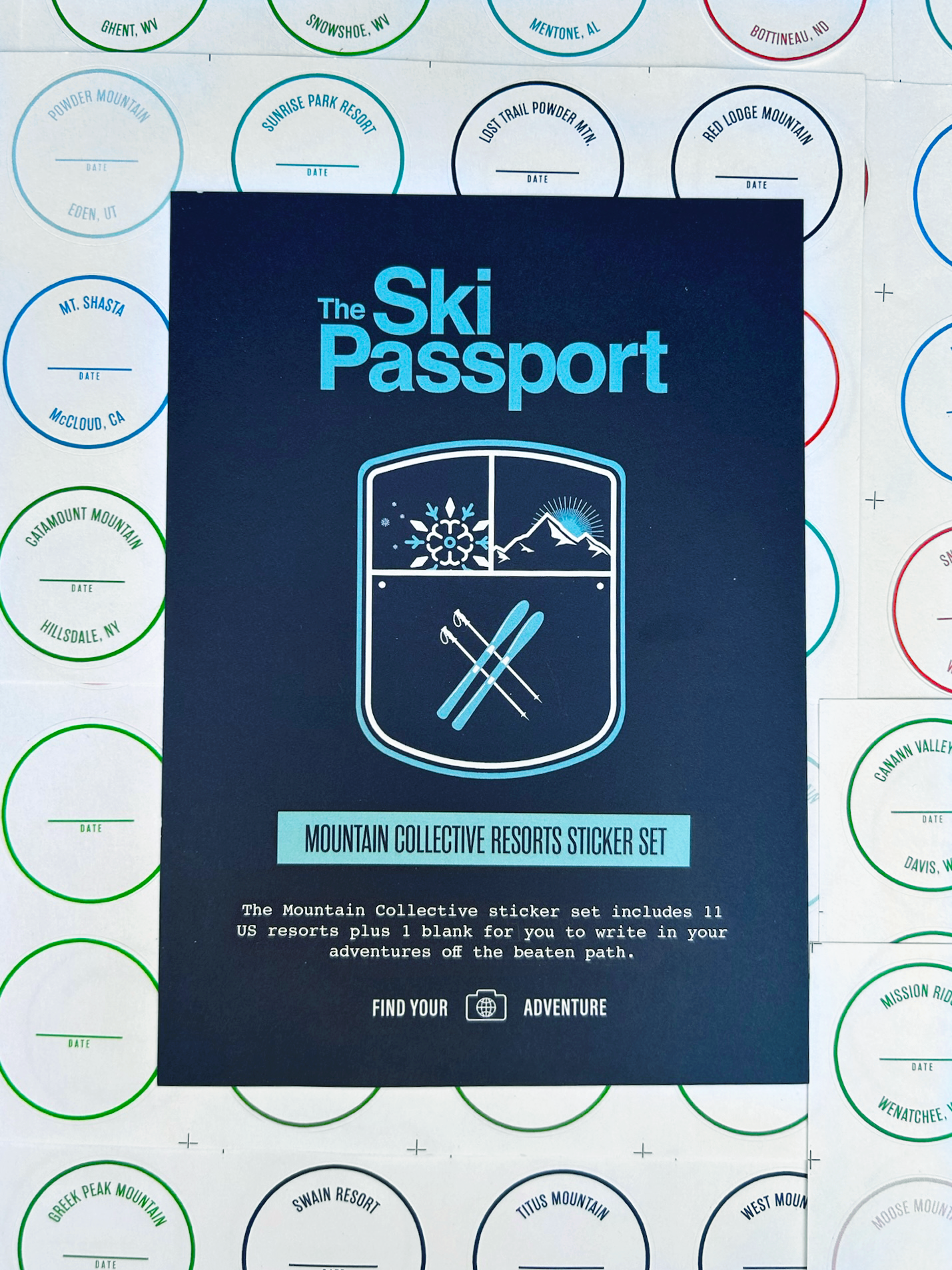 The Ski Passport Mountain Collective ski resort sticker set with ski resort stickers in the background